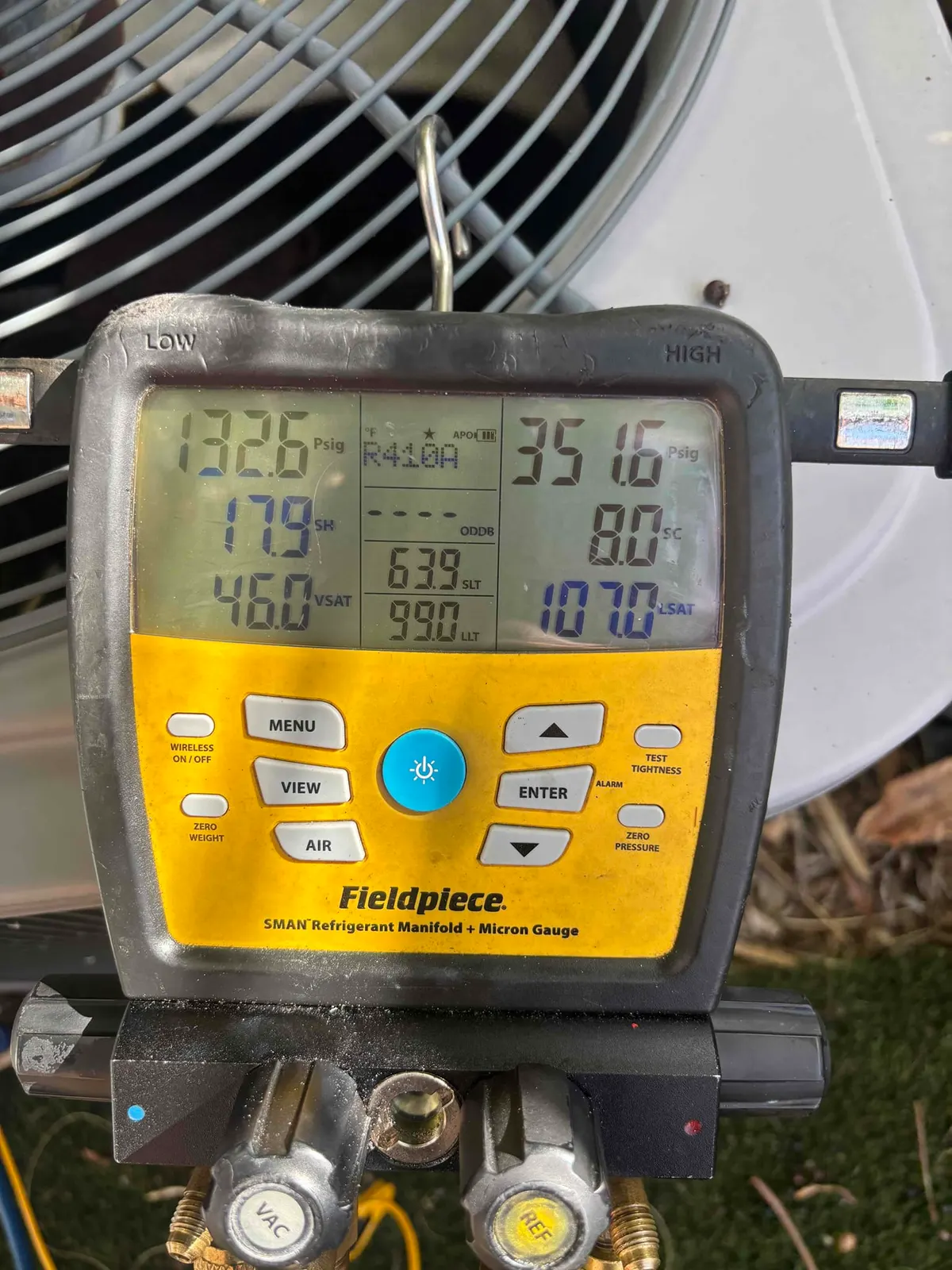 Digital HVAC diagnostic gauge during AC maintenance