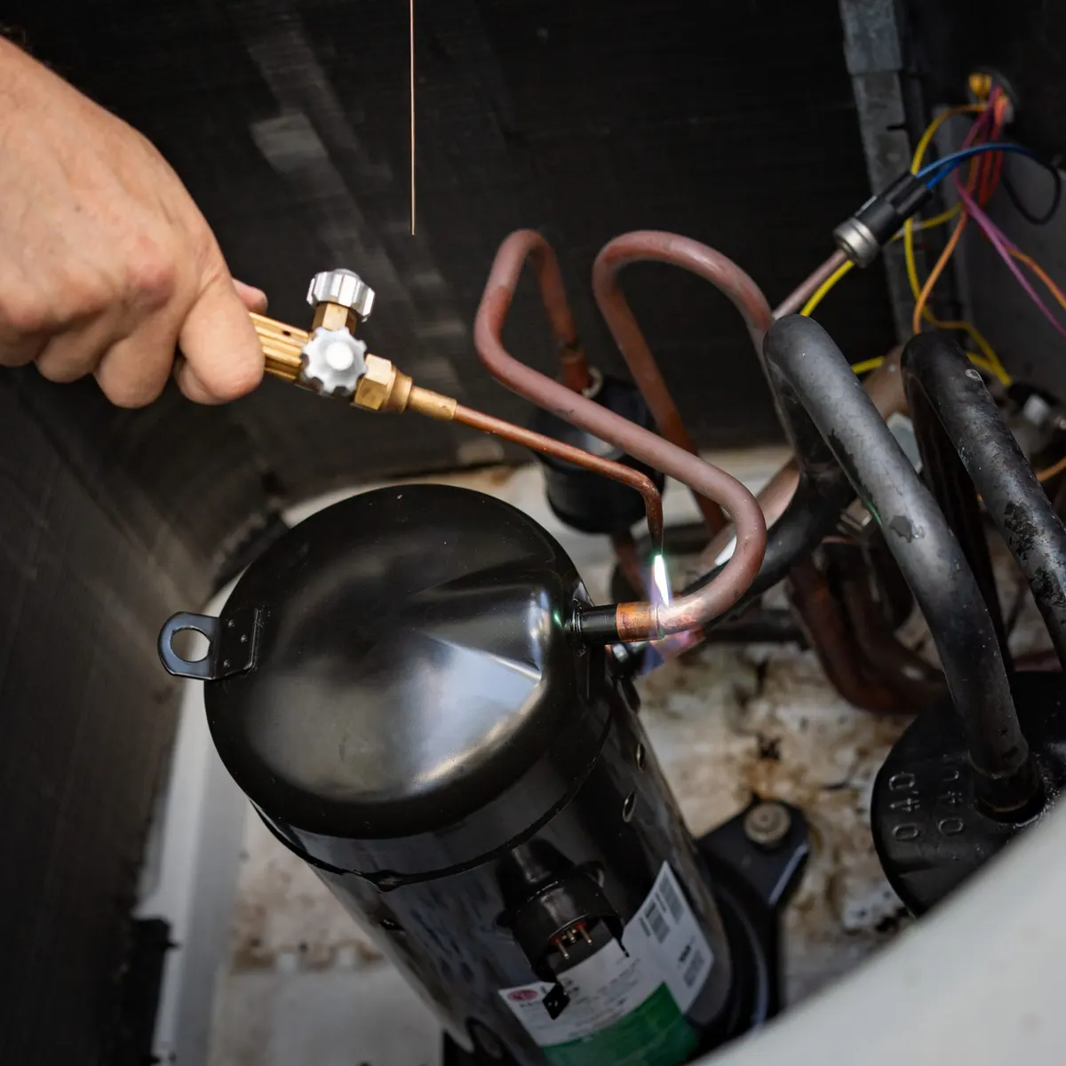 HVAC technician brazing copper refrigerant lines