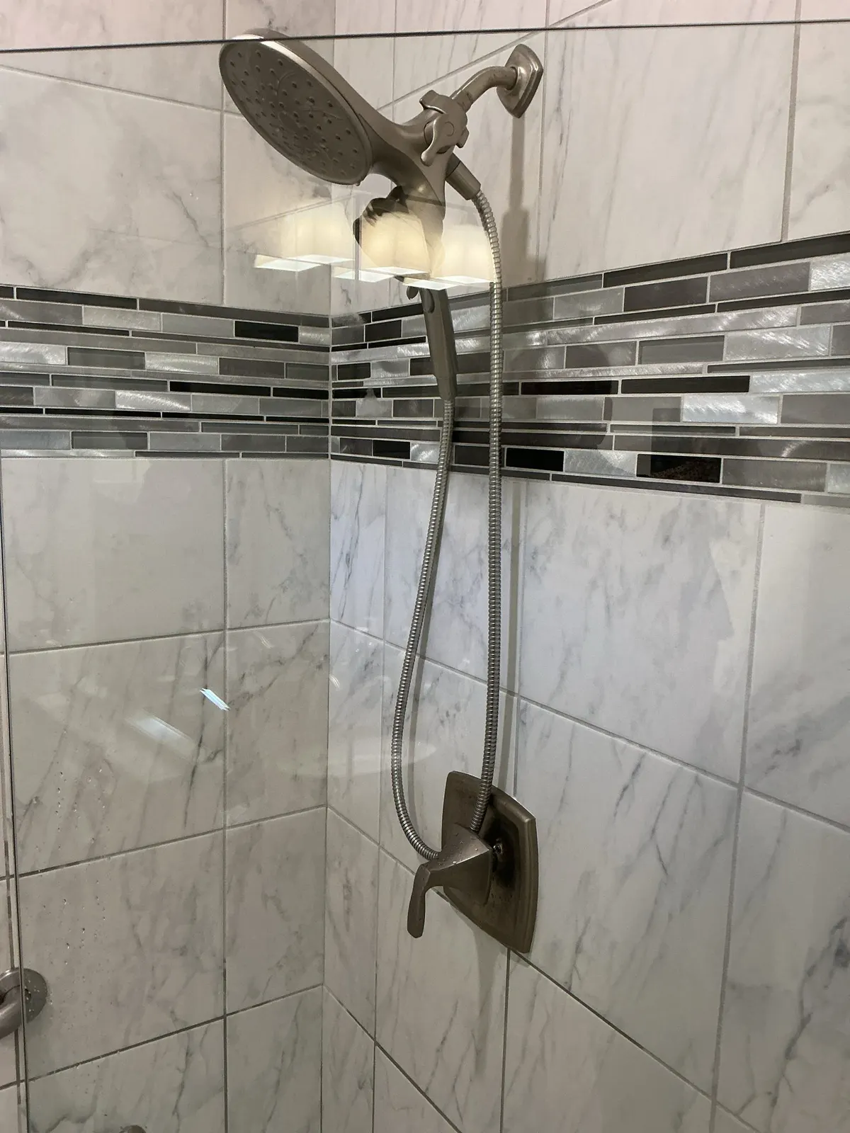Technician repairing shower plumbing