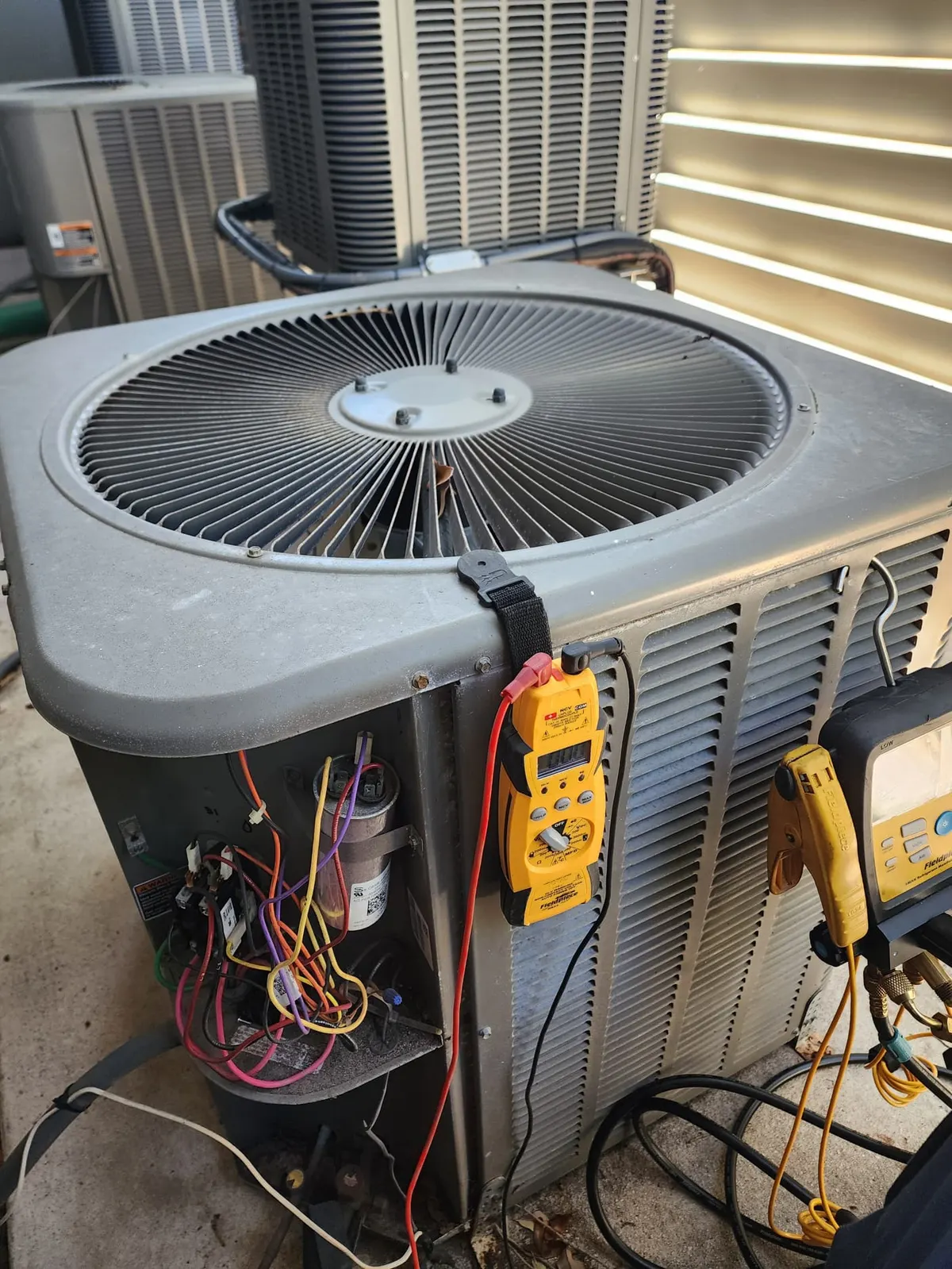 Outdoor air conditioning unit inspected during maintenance