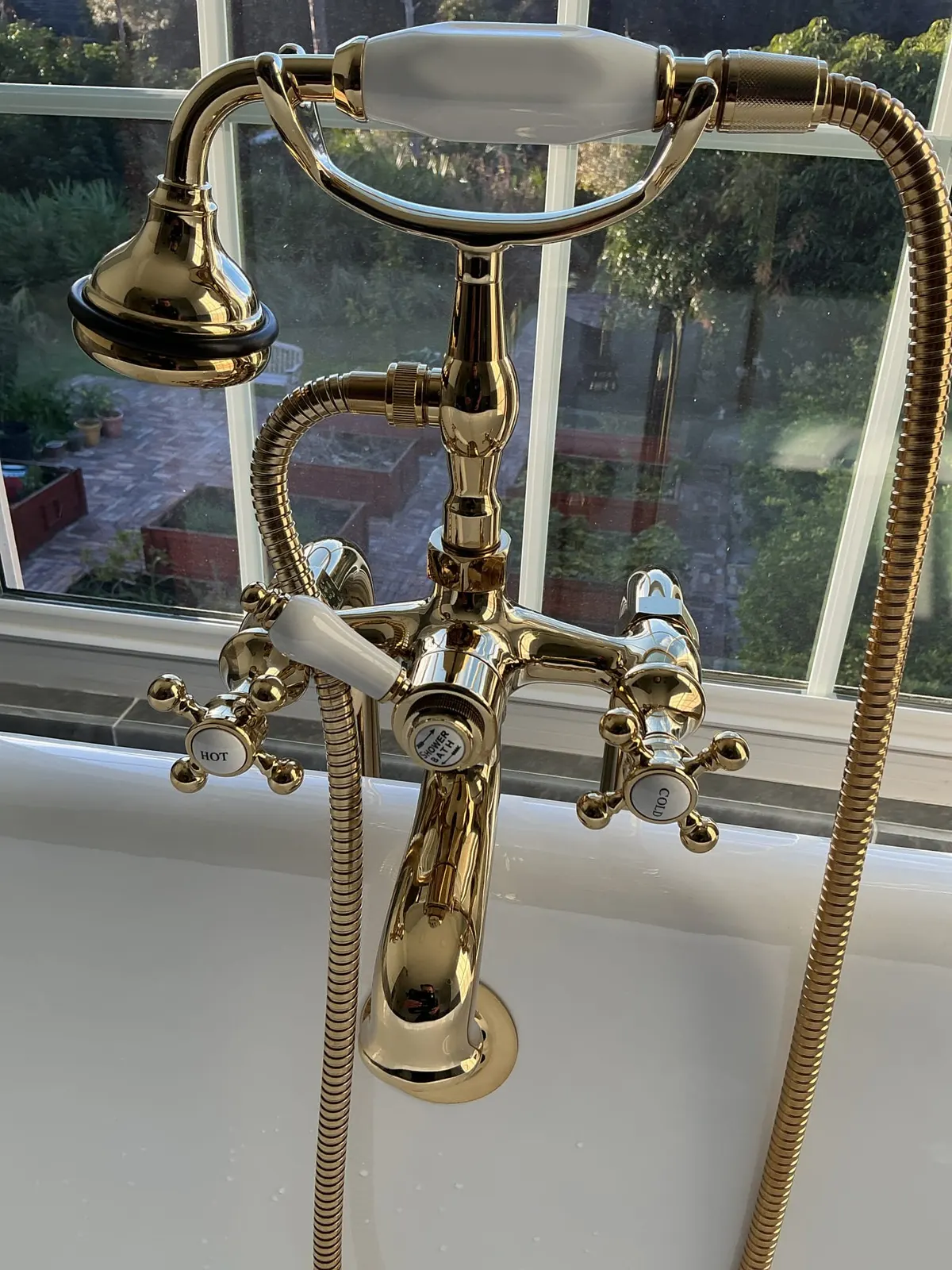 Vintage-style gold bathtub faucet installed