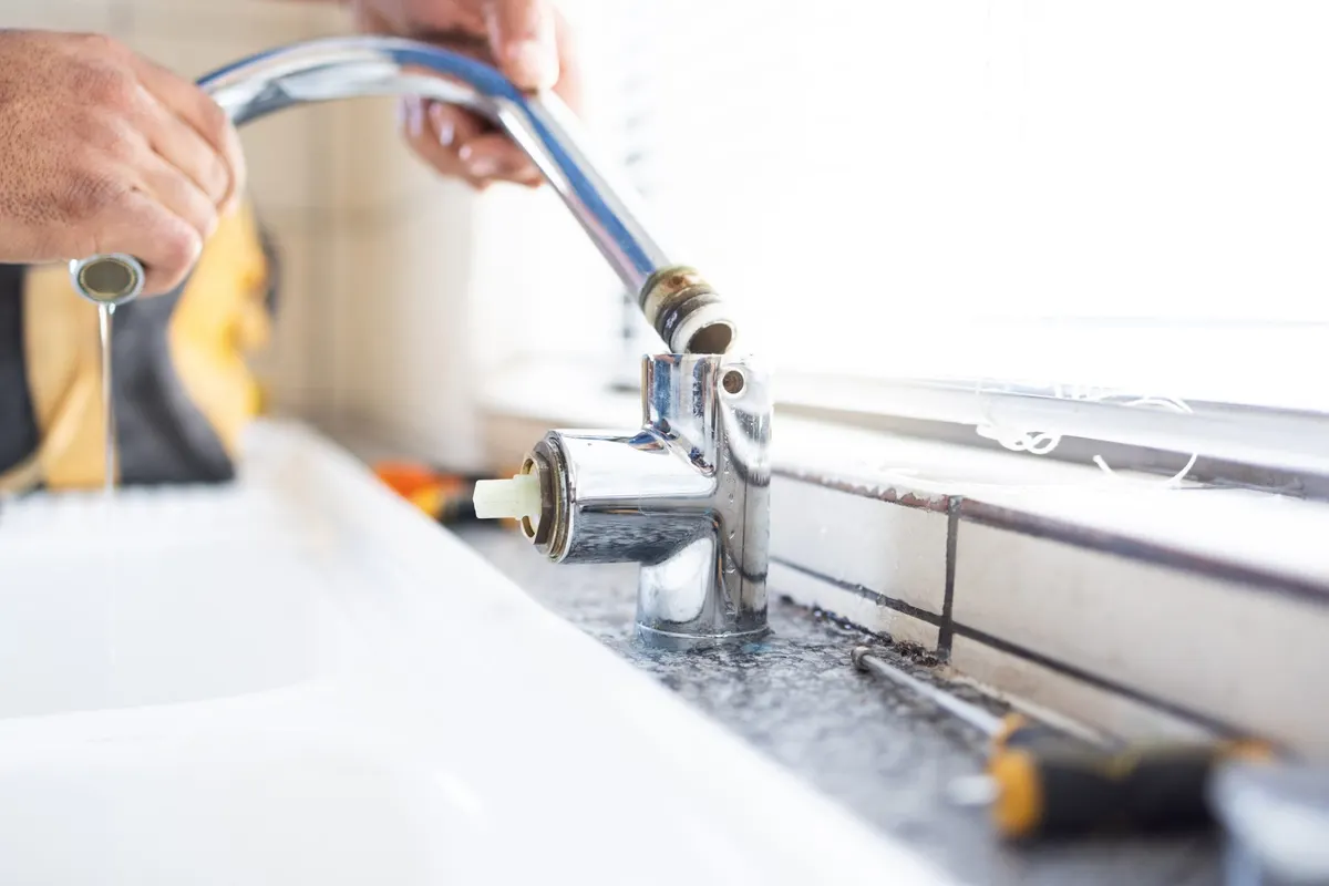 Kitchen faucet being repaired