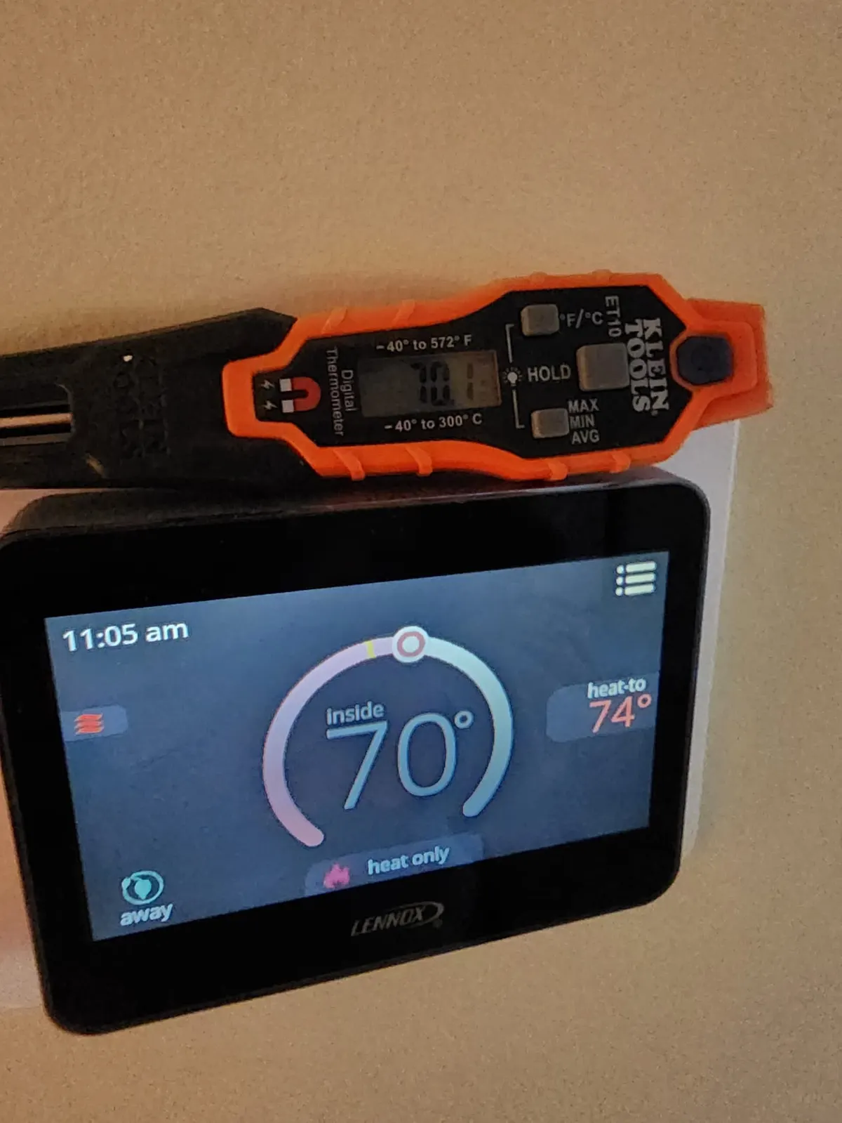 Wall-mounted thermostat being replaced