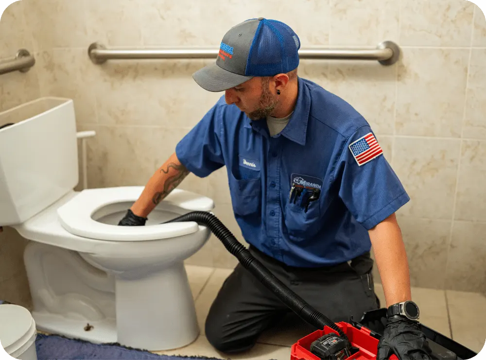 Plumber unclogging a toilet