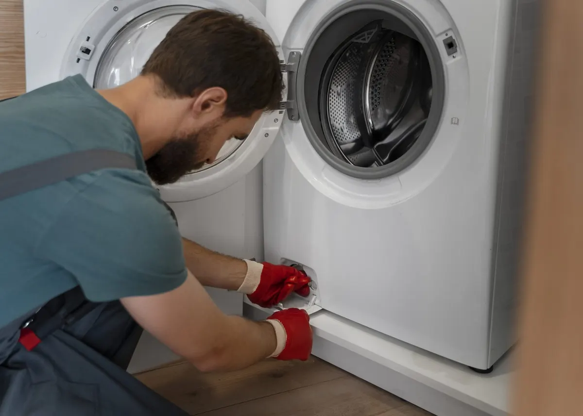Technician repairing a front-load washing machine