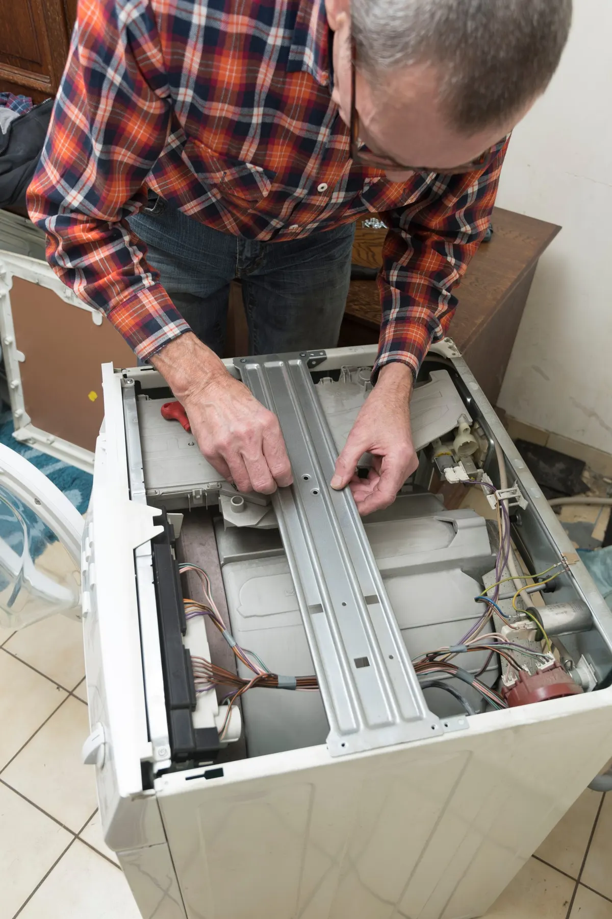 Technician repairing a dryer
