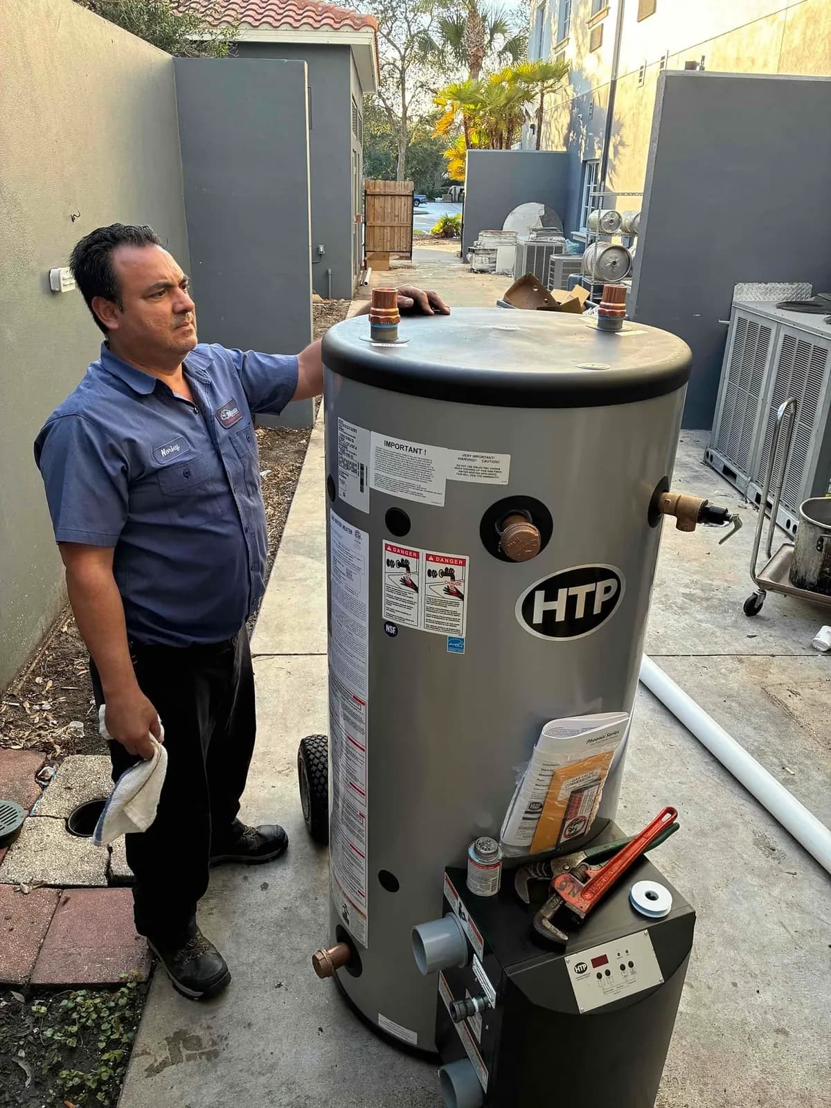 Technician next to a water heater
