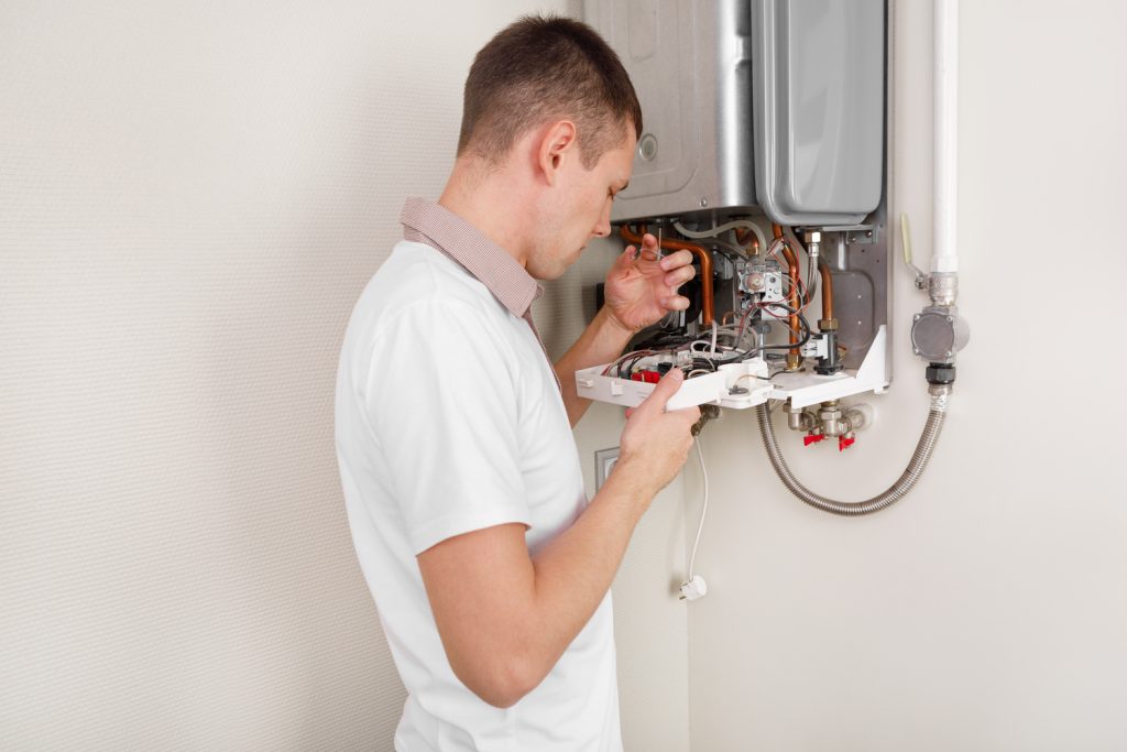 Plumber repairing water heater